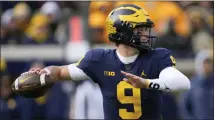  ?? ?? Michigan quarterbac­k J.J. McCarthy (9) throws against Illinois in the first half of Saturday’s game.