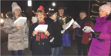  ?? PHOTO BY ANN DAVIDSON ?? Carollers from the Knowlton Players made their way around town during Midnight Madness inviting passers-by to join in with them.