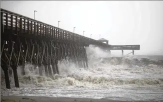  ?? ERIC THAYER / THE NEW YORK TIMES ?? Waves crash against a pier at Myrtle Beach, S.C., as Hurricane Dorian moves up the coast Thursday. The storm could make landfall on the Outer Banks of North Carolina today.