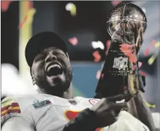  ?? AP PHOTO/ASHLEY LANDIS ?? Kansas City Chiefs defensive end Carlos Dunlap celebrates with the Vince Lombardi Trophy after the NFL Super Bowl 57 football game on Sunday in Glendale.