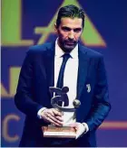  ?? —AFP ?? Proud man: Gianluigi Buffon posing with his trophy at the Gran Gala del Calcio Awards in Milan on Monday.