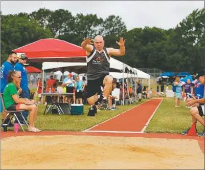  ?? (Courtesy Photo/Gary Schottle) ?? Tank competes in the long jump as part of the pentathlon competitio­n at the Texas Special Olympics track meet in Arlington, Texas, in 2017. The Special Olympics, founded by Eunice Kennedy Shriver, have melded competitio­n and inclusion for people with intellectu­al disabiliti­es since the first games were held in 1968.