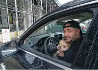  ?? JAMES ESTRIN/NEW YORK TIMES ?? Zach Sobel with his dog, Calvin, in Brooklyn, N.Y., on Dec. 31. Sobel left his car running outside a pet store and came back to find it had been stolen — with his dog, Calvin, inside — because he had left a spare key fob in the car.