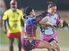  ??  ?? Jumma Gummas’ Tamara White tries to break a Mackay Stallions’ tackle.