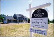  ??  ?? In this Thursday, June 24, 2021file photo, a real estate sign is posted in front of a newly constructe­d single family home in Auburn, N.H.