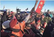  ?? BRIAN POWERS, DES MOINES REGISTER ?? People celebrate Sunday near Cannon Ball, N.D. The Army Corps of Engineers said it was halting work on the Dakota Access Pipeline and considerin­g other routes.