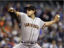  ?? JEFFREY PHELPS – THE ASSOCIATED PRESS ?? Giants starting pitcher Derek Holland allowed two runs in six innings in a 4-2loss to Milwaukee on Friday. Holland didn’t get the decision.