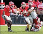  ?? CURTIS COMPTON / CCOMPTON@AJC.COM ?? UGA offensive linemen Solomon Kindley (66) and Andrew Thomas (71) have usually kept pass rushers off QB Jake Fromm this season.