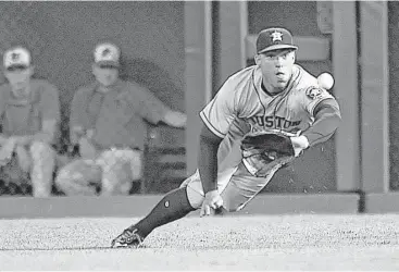  ?? Gail Burton / Associated Press ?? Astros right fielder George Springer had a good day in the field and at the plate, diving to catch a liner from Orioles shortstop J.J. Hardy in the third inning while also going 3-for-4 at the plate with a home run.