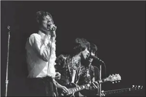  ?? The Associated Press ?? THE ROLLING STONES: In this April 11, 1967, file photo, Mick Jagger, from left, Keith Richards, and Bill Wyman of The Rolling Stones perform in Paris. The band is just one of many musical astonishme­nts of 1967 that shaped what we listen to now. The...