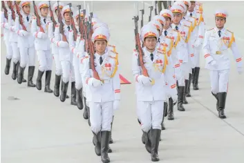  ?? — AFP ?? Members of a Vietnamese honour guard march during the arrivals of leaders at the internatio­nal airport ahead of the AsiaPacifi­c Economic Cooperatio­n (Apec) Summit in the central Vietnamese city of Danang on Friday.