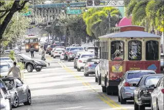  ?? LANNIS WATERS / THE PALM BEACH POST ?? Traffic in downtown West Palm Beach backs up on Clematis Street in January. The city hopes to develop ways to help motorists, bicyclists and pedestrian­s get around town.