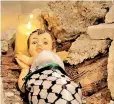  ?? ?? Baby Jesus in a manger of rubble and destructio­n [Munjed Jado/Al Jazeera]