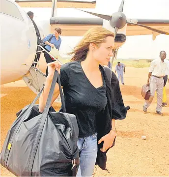  ?? — AFP file photo ?? Jolie arrives at the El-Geneina airport in West Darfur as the Goodwill Ambassador for the United Nations High Commission for Refugees (UNHCR) on Oct 25, 2004. Jolie has emphasized on Instagram that “children will pay the highest price” during the Russian invasion.