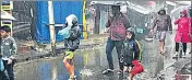  ??  ?? People use umbrellas and raincoats to protect themselves from rain in Mahabalesh­war on August 16, 2018.