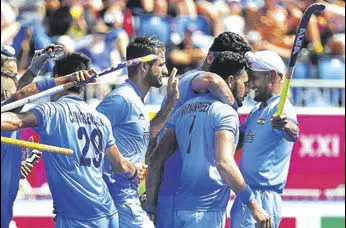  ?? AFP ?? Harmanpree­t Singh (second from right) is congratula­ted by teammates after scoring his second goal against Malaysia on Tuesday. India won 21.