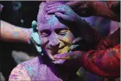  ?? CHANNI ANAND — AP PHOTO ?? Indians smear colored powder on each other as they celebrate Holi in Jammu, India. Holi, the Hindu festival of colors, also heralds the arrival of spring.