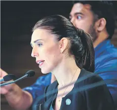  ??  ?? Ardern speaks during a Post Cabinet media press conference at Parliament in Wellington. Partially seen behind her is Peters.— AFP photo