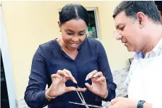  ??  ?? Managing Director of Jamaica Warehouse Nesha Hoo Kim tastes a piece of the steak from Gunnie’s grill.