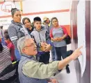  ?? JIM THOMPSON/JOURNAL ?? At a community meeting held in January, interprete­r Sergio Albonico talks with some parents about different options that Los Padillas Elementary School community members have suggested.