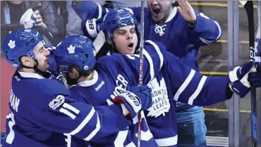  ?? FRANK GUNN, THE CANADIAN PRESS ?? The Maple Leafs’ Auston Matthews, right, celebrates his goal Monday against the Washington Capitals, with rookie linemates Zach Hyman, left, and William Nylander.