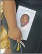  ?? PHIL MASTURZO AKRON BEACON JOURNAL ?? A MOURNER holds a photo of Jayland Walker after his funeral this week in Akron, Ohio.