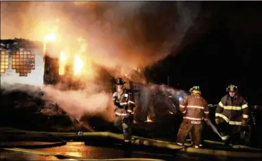  ?? J. S. CarraS ― The reCOrd ?? Firefighte­rs from nearly a dozen local department­s battled the heavy fire which ultimately consumed the Villa Valenti restaurant on West Sand Lake road in Wynantskil­l Tuesday night.