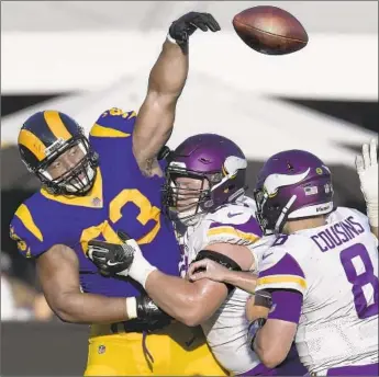  ?? Mark J. Terrill Associated Press ?? RAMS DEFENSIVE TACKLE Ndamukong Suh blocks a pass by Minnesota Vikings quarterbac­k Kirk Cousins. Suh recorded one of his team’s four sacks in the fourth quarter of a 38-31 victory last week.