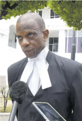  ?? (Photos: Naphtali Junior) ?? Defence Lawyer Lloyd Mcfarlane speaks with members of the media following the end of the summation in the Uchence Wilson gang trial. Mcfarlane represente­d Wilson, who was found guilty of being the leader of the criminal outfit among other charges.