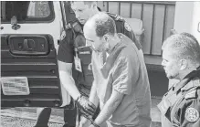  ?? ANDREW VAUGHAN THE CANADIAN PRESS ?? Matthew Vincent Raymond, charged with four counts of first degree murder, is taken from provincial court in Fredericto­n on Monday.