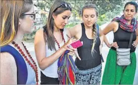  ??  ?? A group of women from Argentina, who were on a visit to BHU condemned the acid attack. (Right) A bedsheet that got burnt in the acid attack on the Russian woman at a house in Nand Nagar locality in Varanasi on Friday.