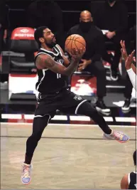  ?? Al Bello / Getty Images ?? The Nets’ Kyrie Irving drives to the basket against the Jazz on Jan. 5.