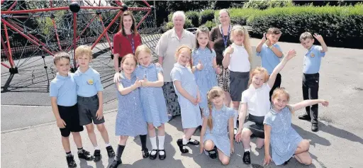  ??  ?? ●●Councillor Sheila Bailey and schoolchil­dren look forward to the new play equipment at Alexandra Park, Edgeley