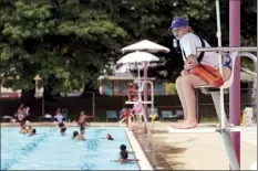  ?? AP photo ?? Lifeguard Elizabeth Conley keeps an eye on the swimmers at the Douglass Park pool in Indianapol­is on Friday. Indianapol­is typically fills 17 pools each year, but with a national lifeguard shortage exacerbate­d by the COVID-19 pandemic, just five are open this summer. The American Lifeguard Associatio­n estimates one-third of pools in the United States are impacted by the shortage.