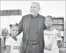  ??  ?? Minister George Norton shares a light photo moment with Emmanuella (right) and her cousin Success.