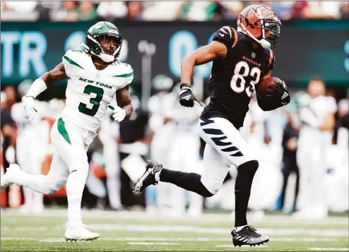  ?? Sarah Stier / Getty Images ?? The Bengals' Tyler Boyd runs past the Jets' Jordan Whitehead for a touchdown on Sunday.