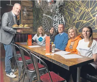  ?? Picture: Newsline Media. ?? Garreth Wood serves up lunch to Lisa Duthie, of Cornerston­e; Michelle Ferguson, from Cash for Kids; Brian Walsh, Grampian Autistic Society; Lynn Batham, of Charlie House; and Lois Murray, Aberdeen Cyrenians.