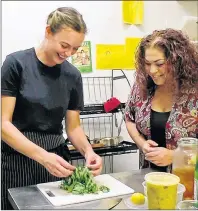  ?? NIGEL ARMSTRONG/THE GUARDIAN ?? Chef Sarah Forrester-Wendt, left, and chef Ilona Daniel work in the kitchen of My Plum, My Duck restaurant, preparing collard greens to accompany Forrester-Wendt’s vegan “crab” cakes.