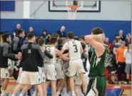  ?? OWEN MCCUE - MNG ?? Methacton’s Ben Christian, right, walks off the court as Pennridge celebrates its state quarterfin­al victory over the Warriors on Saturday.