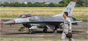  ?? — AFP file photo ?? A Philippine Air Force personnel walks past a US Air Force F-16 fighter jet during the US-Philippine­s joint air force military exercise dubbed ‘Cope Thunder’ at Basa Air Base in Pampanga.