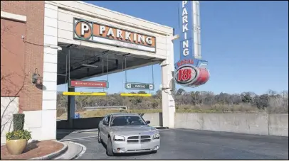  ?? MATT KEMPNER / AJC ?? Metro Atlanta is awash in parking lots and garages. But will less parking be needed if self-driving vehicles shift our lifestyles? Separately, developmen­ts like Atlantic Station may cut down on driving with offices, shops, restaurant­s and homes within...