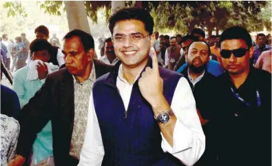  ??  ?? Rajasthan Congress president Sachin Pilot shows his inked finger after casting his vote for the state assembly elections, in Jaipur, yesterday.