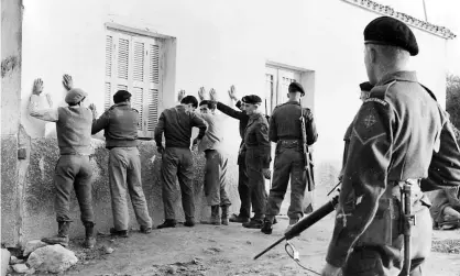  ??  ?? British troops stationed in the Kyrenia mountains search villagers during a patrol against Eoka, the guerrilla group the claimants were members of. Photograph: taken from picture library