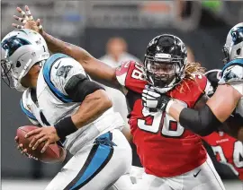  ?? CURTIS COMPTON / CCOMPTON@AJC.COM ?? Panthers quarterbac­k Cam Newton gets flushed out of the pocket by defensive end Takk McKinley last weekend in Atlanta. McKinley is tied for the team lead with two sacks but will be slowed by a groin injury, if he plays.