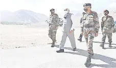  ?? — AFP photo ?? Modi (centre) walks with arrives in Leh, the joint capital of the union territory of Ladakh.