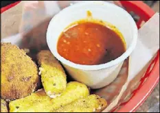  ?? PHOTOS BY BECKY STEIN PHOTOGRAPH­Y ?? Rice balls made of risotto, pecorino and mozzarella alongside a homemade mozzarella stix appetizer.