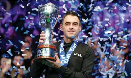  ?? ?? Ronnie O'Sullivan celebrates with the trophy after winning the UK Championsh­ip against Ding Junhui. Photograph: Mike Egerton/PA