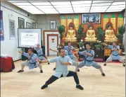 ?? LIA ZHU / CHINA DAILY ?? Yan Ran (front), chairman of Shaolin Temple USA, and kung fu instructor­s practice qigong exercise ba duan jin (eight section brocade) at a Shaolin culture center in San Francisco.