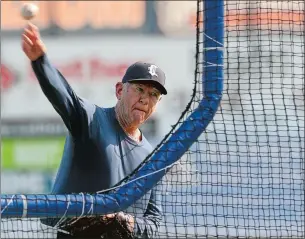  ?? DANA JENSEN/THE DAY ?? Andy Baylock, 80, throws batting practice for the Connecticu­t Tigers before their game at Dodd Stadium in Norwich on Thursday night.