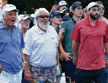  ??  ?? John Daly, second from left, watches his second shot on No. 17. The 2017 Insperity champion was at 5 under before closing with a double bogey to finish the day at 3-under-69 and tied for second, two shots back.